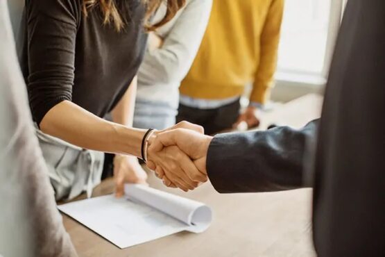 A handshake during a business meeting at a table